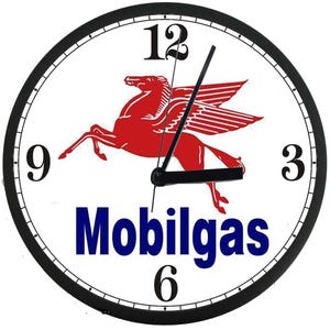 May include: A white clock face with black numbers and hands. The clock face features a red winged horse with the word "Mobilgas" in blue letters.