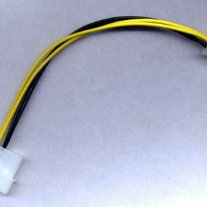 May include: A black and yellow computer power supply cable with two white connectors.