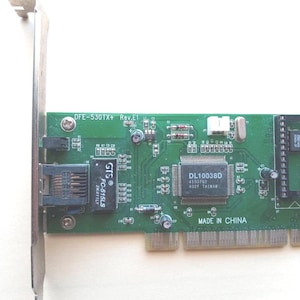 May include: A green DFE-530TX+ Rev.E1 network card with a metal bracket. The card features various electronic components, including a DL10038D chip and the text "MADE IN CHINA".