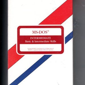 May include: A white VHS video tape box with diagonal red and blue stripes. The text reads Video Projects QuickStudy Video, MS-DOS Intermediate Basic & Intermediate Skills, and VIDEOLOCK COPY PROTECTED with additional copyright and legal text.