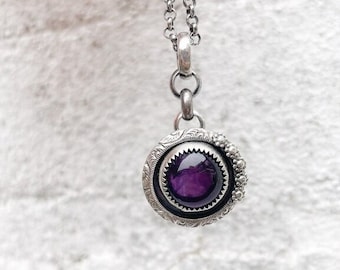 Sterling silver handmade pendant with a beautiful dark purple Amethyst cabochon.