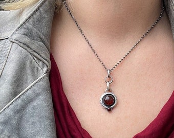 Sterling silver handmade pendant with two beautiful orange red Carnelian cabochons.