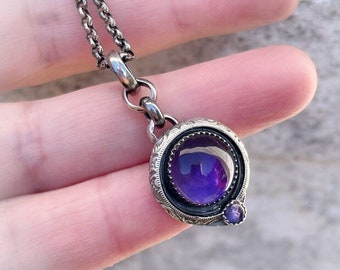 Sterling silver handmade pendant with two beautiful purple Amethyst cabochons.