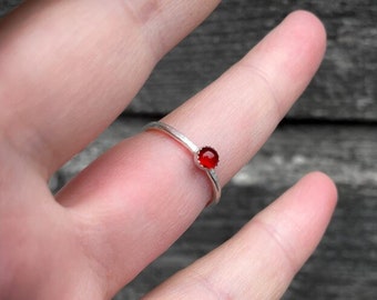 Handmade silver stacking ring with a 4mm Carnelian cabochon in a serrated setting.