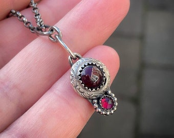 Sterling silver handmade pendant with two beautiful red Garnet cabochons.