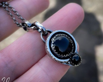 A Sterling silver handmade pendant with two beautiful black Onyx cabochons.