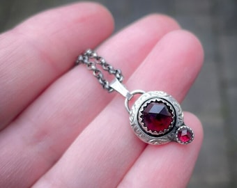 Sterling silver handmade pendant with two beautiful red rose cut Garnet cabochons.