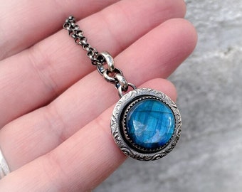 A unique handmade pendant made of Sterling silver with a 14mm Labradorite in a serrated setting.