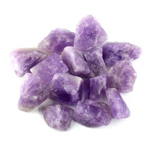 May include: A collection of raw amethyst crystals in various sizes and shapes. The crystals are a deep purple color and have a natural, rough texture.