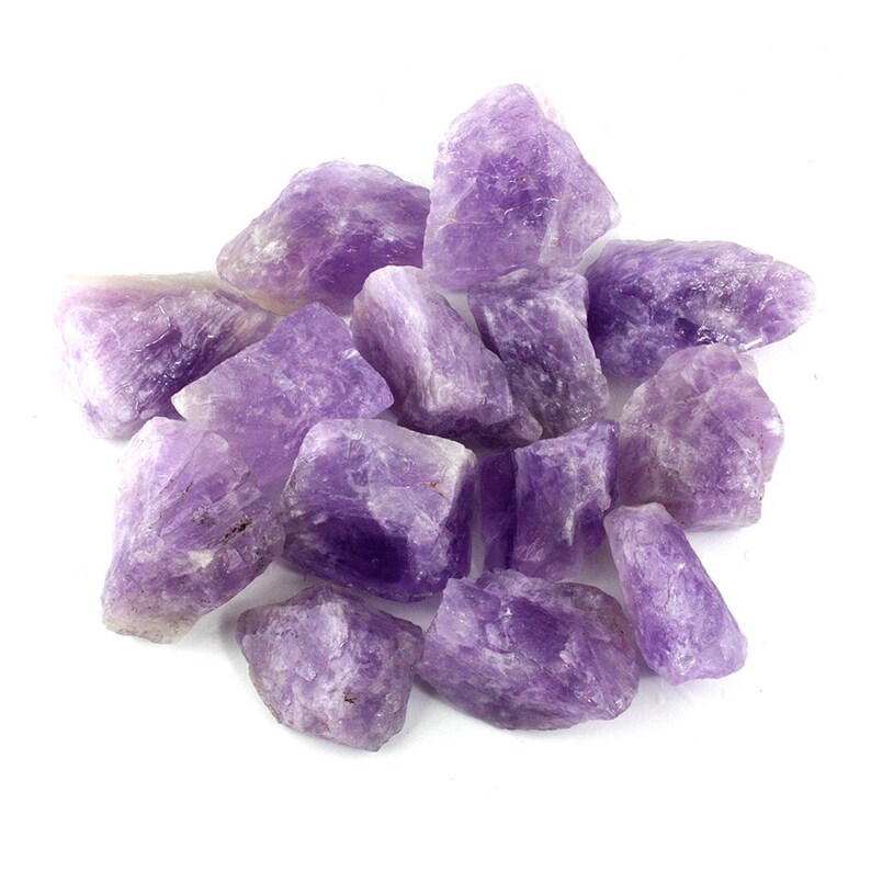 May include: A collection of raw amethyst crystals in various sizes and shapes. The crystals are a deep purple color and have a natural, rough texture.