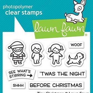 May include: Clear photopolymer stamps featuring Christmas-themed illustrations, including Santa Claus, children, a deer, and a dog. Text includes "WOOF", "SEE WHAT'S STIRRING", "'TWAS THE NIGHT", "SHHH", and "BEFORE CHRISTMAS". The Lawn Fawn brand is visible.