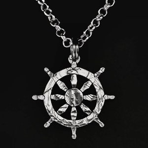 Buddhist Wheel cut from a quarter coin jewelry