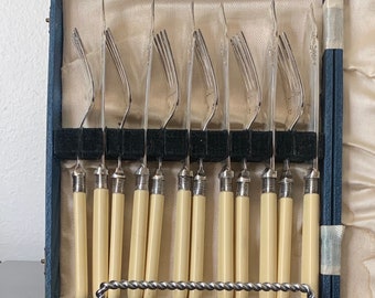 12 piece fish fork and knife set in original box, 6 forks and 6 knives.