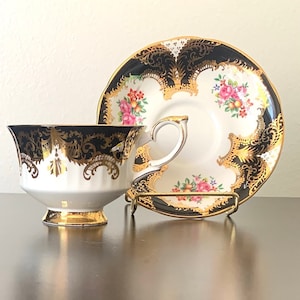 Paragon fine bone china cup and saucer, pink roses on black and white with gold. By Appointment to Her Majesty the Queen, Paragon Potters.