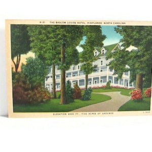 May include: Vintage postcard featuring The Bascom-Louise Hotel in Highlands, North Carolina. The image shows a white building with a green roof, surrounded by trees and a winding driveway. The text reads "ELEVATION 4000 FT., FIVE ACRES OF GROUNDS."