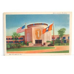 May include: Vintage postcard featuring the Administration Building at the New York World's Fair. The building is a light beige color with a circular top and a large emblem. The American flag and another flag are waving in the wind. The text "New York World's Fair" is at the bottom.