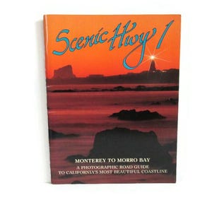 May include: A vintage travel guide titled "Scenic Hwy 1" with a sunset scene and a lighthouse. The cover reads "Monterey to Morro Bay" and "A Photographic Road Guide to California's Most Beautiful Coastline."