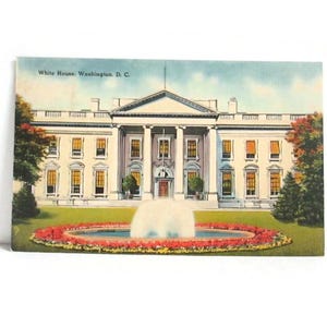 May include: Vintage postcard featuring the White House in Washington, D.C. The image shows the iconic building with a fountain in front, surrounded by a garden of red and yellow flowers. The sky is a light blue.