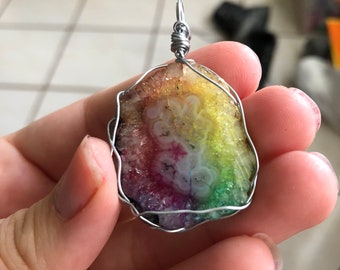 Rainbow solar quartz pendant necklace .