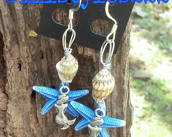 Syrena z rozgwiazdą i muszlami.