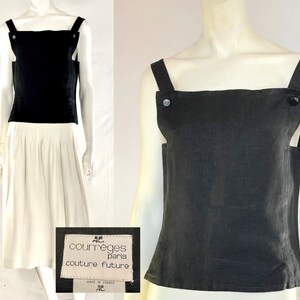May include: A black sleeveless top with wide shoulder straps and large buttons. The top is paired with a white skirt. The label reads "courr&egrave;ges paris couture future".