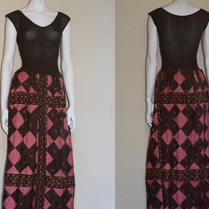 May include: A brown sleeveless dress with a fitted bodice and a patchwork skirt. The skirt is made of brown and pink fabric with a diamond pattern.