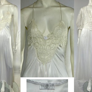 May include: White satin nightgown with lace detailing and a V-neckline. The gown has adjustable straps and a label that reads "Val Mode Lingerie, Made in U.S.A."