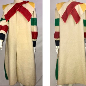 May include: A vintage cream-colored coat with a colorful collar and striped sleeves. The collar features red, yellow, and white accents. The sleeves have red, green, and blue stripes. The coat is long and has a simple, elegant design.