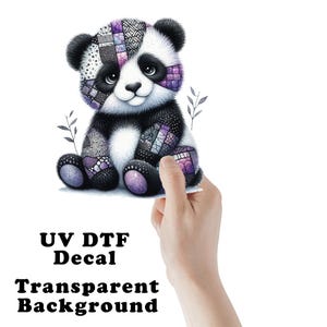 May include: A cute panda bear decal with a patchwork design in shades of purple, black, and white. The panda is sitting with a smiling face. The text "UV DTF Decal Transparent Background" is at the bottom.