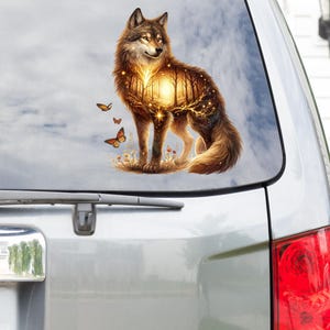 May include: A wolf with a forest scene inside its body, surrounded by butterflies. The wolf is standing on a grassy area with a sunset in the background.