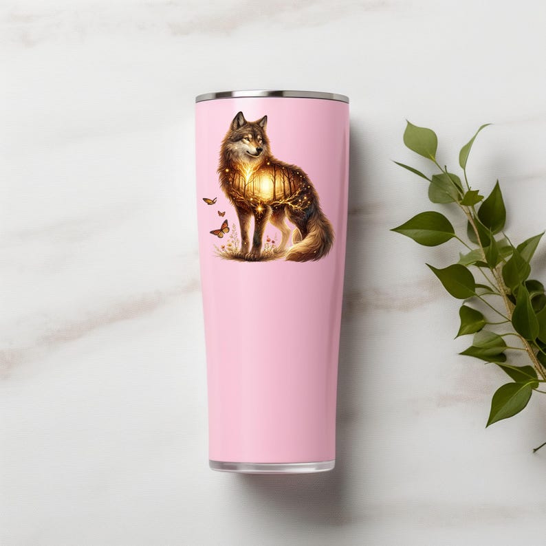 May include: A pink stainless steel tumbler with a wolf silhouette design. The wolf is surrounded by a glowing forest scene with butterflies.