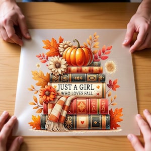 May include: A stack of four vintage-style books topped with an orange pumpkin and autumn flowers. A plaid scarf drapes over the books. The middle book features the text "JUST A GIRL WHO LOVES FALL." The illustration is surrounded by colorful fall leaves.