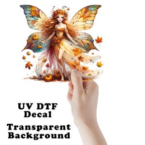 May include: A UV DTF decal with a transparent background. The image features a fairy with long, flowing red hair, adorned with a floral crown and a dress decorated with autumn leaves and pumpkins. The fairy has large, colorful wings.
