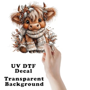 May include: A UV DTF decal featuring a fluffy brown Highland calf wearing a patterned winter scarf and matching mittens, adorned with holly berries and silver leaves. The design includes a transparent background and the text UV DTF Decal.