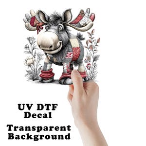 May include: A whimsical cartoon moose with patchwork patterns on its body and antlers. The moose has a friendly expression and is surrounded by floral illustrations. The text "UV DTF Decal Transparent Background" is visible at the bottom.