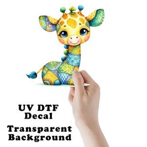 May include: A colorful giraffe decal with a patchwork design. The giraffe has large blue eyes and is holding a small piece of paper. The text "UV DTF Decal Transparent Background" is printed below the giraffe.