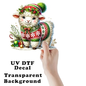 May include: A festive Christmas-themed UV DTF decal featuring a cute sheep wearing a red and green sweater, hat, and wreath. The sheep is adorned with snowflakes and Christmas decorations. The decal has a transparent background.