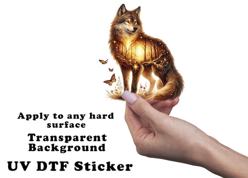 May include: A golden wolf with a forest scene inside its body, surrounded by butterflies. The wolf is being held by a hand. The text "Apply to any hard surface Transparent Background UV DTF Sticker" is below the image.