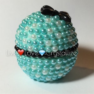 Cute Blue with white polka dots and black bow eos lip balm.