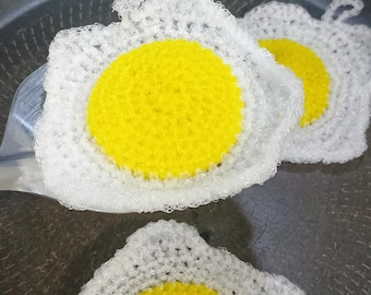Crochet sunny side up fried egg dish scrubby. Useful kitchen decor.