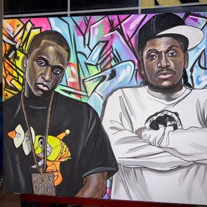 May include: A vibrant painting featuring two men in front of a graffiti-style background. One man wears a black t-shirt with a gold chain and the words "RE-UP GANG". The other man is in a white long-sleeve shirt and a black and white cap.
