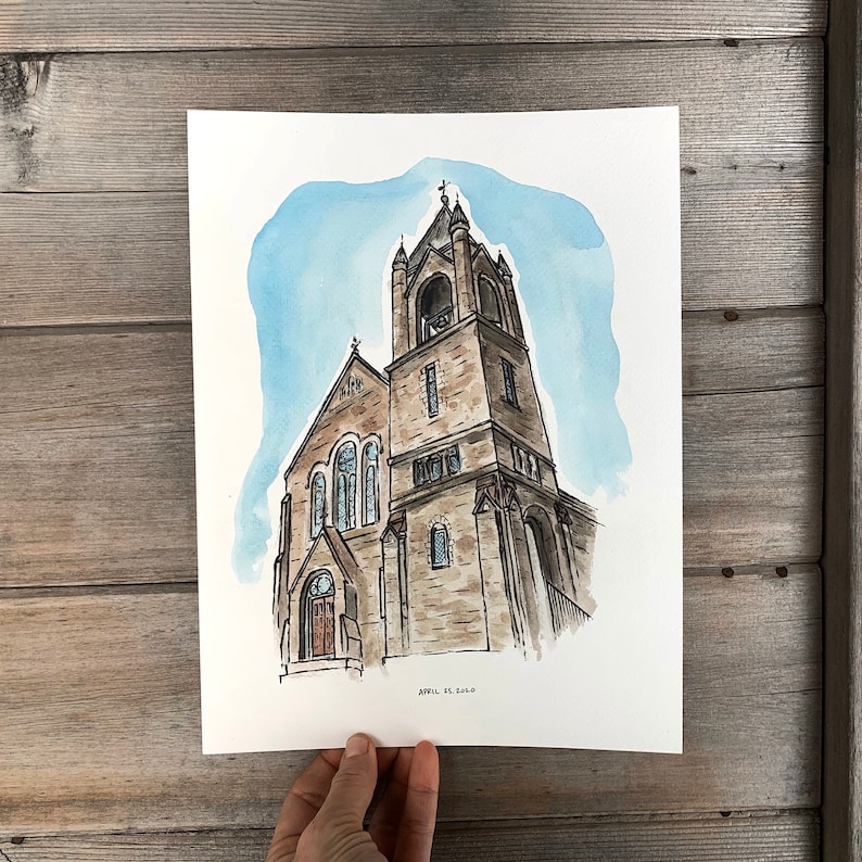 May include: Watercolor painting of a church with a tall tower and a bell. The church is painted in shades of brown and gray, with a blue sky in the background. The painting is signed "April Es Sold" in the bottom right corner.