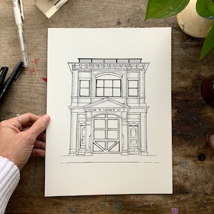 K&ouml;nnte beinhalten: Schwarz-wei&szlig;-Zeichnung eines Geb&auml;udes mit dem Text "HOOK & LADDER NO. 5" &uuml;ber dem Eingang. Das Geb&auml;ude hat zwei Fenster im zweiten Stock und ein gro&szlig;es Garagentor im Erdgeschoss.