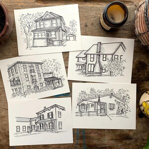 May include: Five black and white ink drawings of houses on white card stock. Each drawing features a different house with varying architectural styles and landscaping.