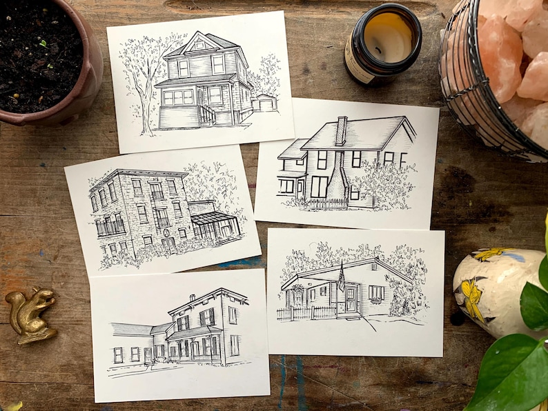 May include: Five black and white ink drawings of houses on white card stock. Each drawing features a different house with varying architectural styles and landscaping.
