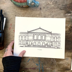 May include: A black and white line drawing of a building with a large arched entrance and multiple windows. The drawing is on a white piece of paper and the text "The Edge" is written below the building.