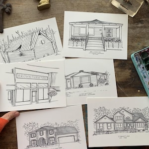 May include: Five black and white line drawings of different buildings on white card stock. The drawings are of a house, a store, and three different homes. The drawings are all done in a simple style and are very detailed.
