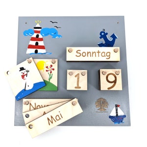 May include: A wooden calendar with interchangeable cards for days of the week, dates, months, and weather. The calendar features a lighthouse, a snowman, a flower, an anchor, and a sailboat.