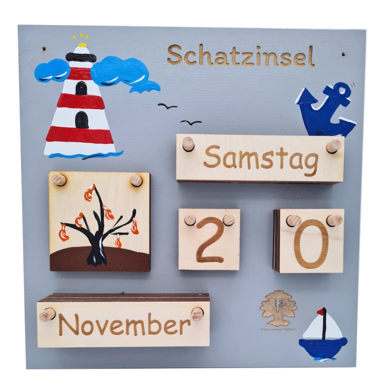 May include: A wooden calendar with a gray background and colorful illustrations. The calendar features a lighthouse, a tree, an anchor, and a sailboat. The date is set to November 20th, and the day of the week is Saturday. The calendar also includes the text "Schatzinsel".