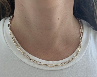 モダンな幾何学模様のゴールドトーンネックレス。オープンヘキサゴン